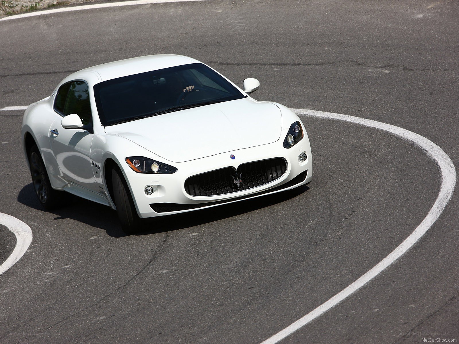 white Maserati on track