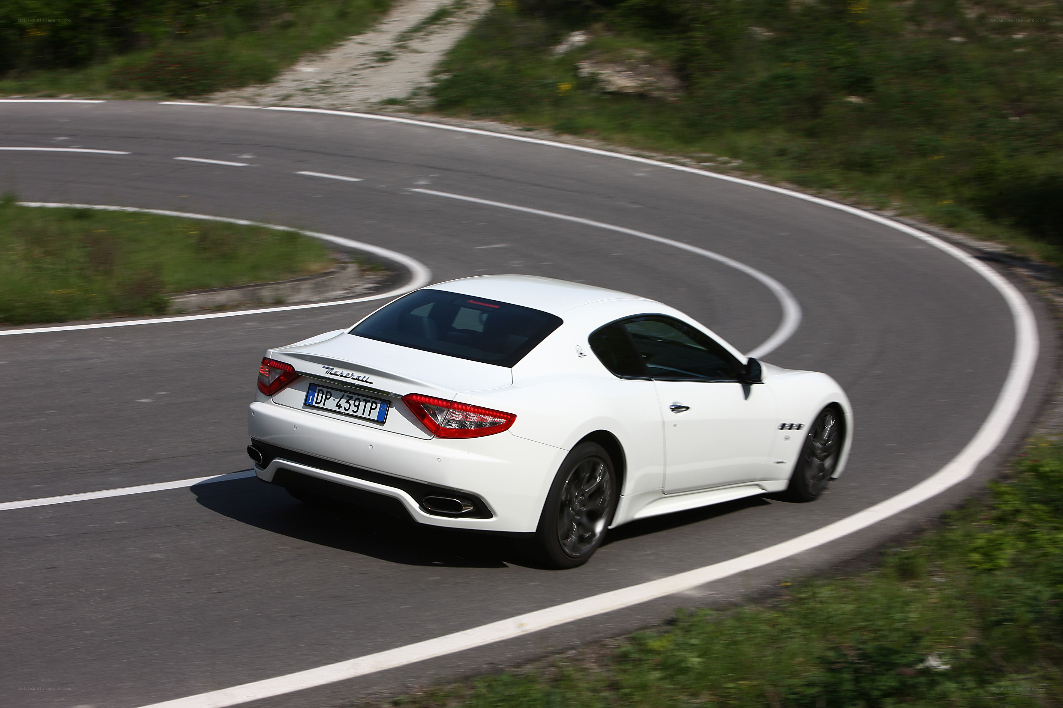 White Maserati on winding road