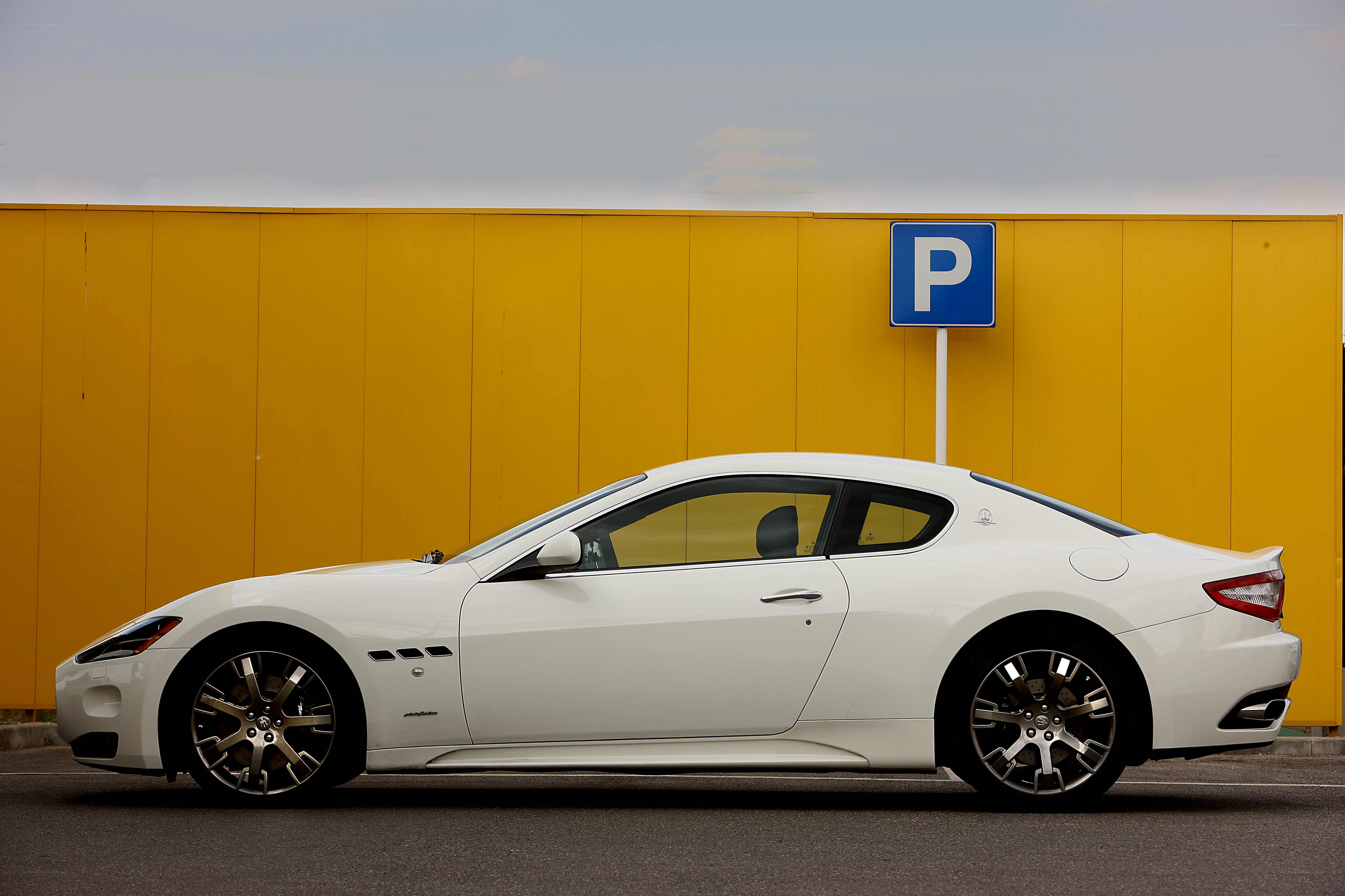 White Maserati on yellow background
