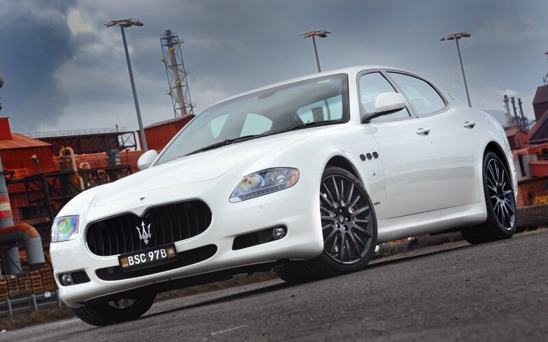 White Maserati sedan in industrial area