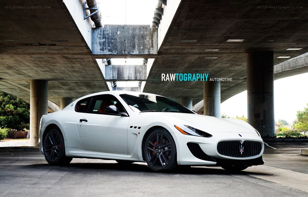White Maserati under a bridge