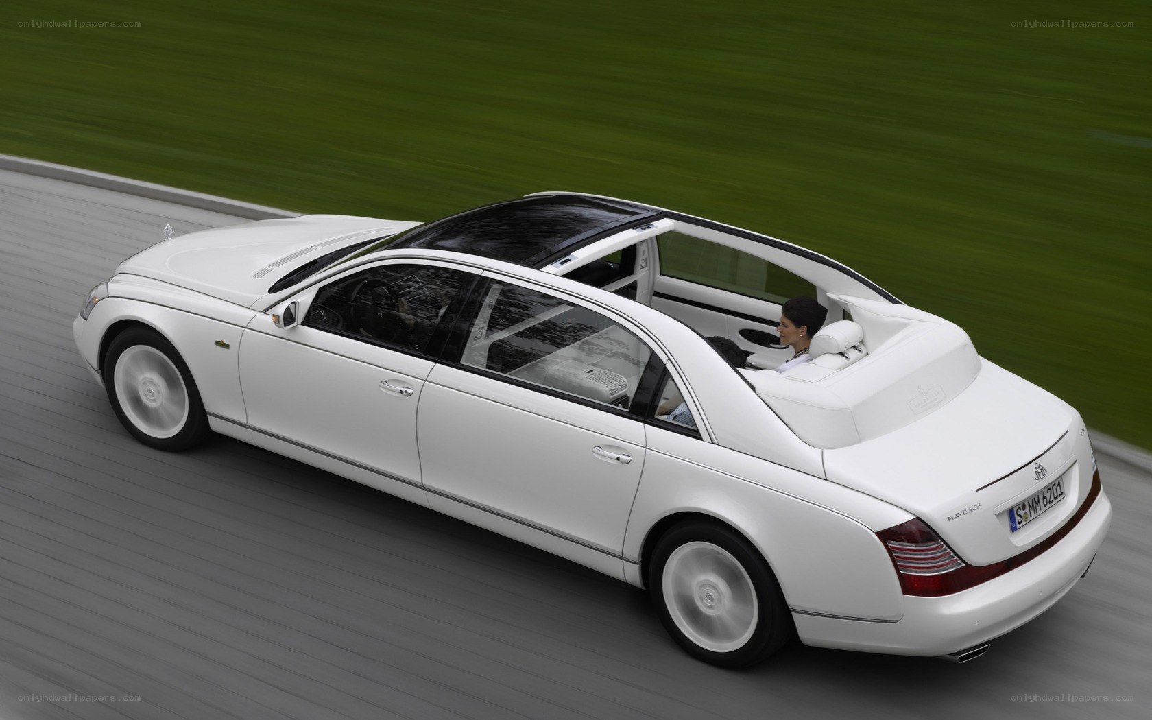 White Maybach driving on road