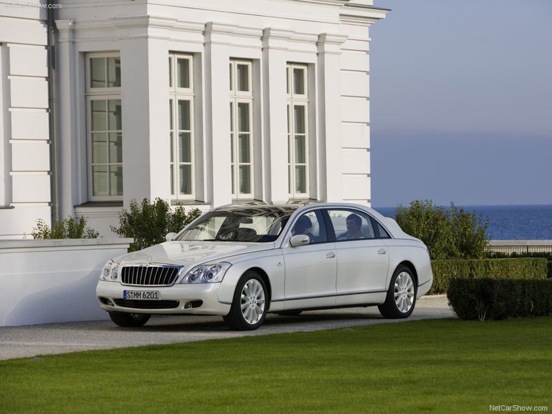 white maybach sedan by the sea