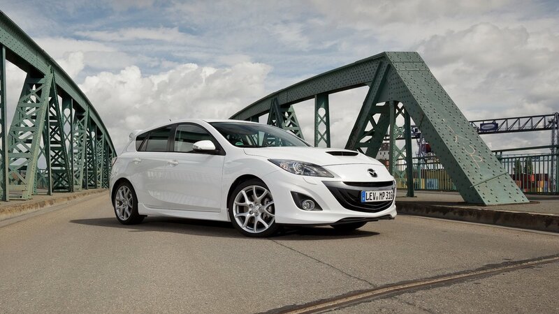 White Mazda 3 on a bridge