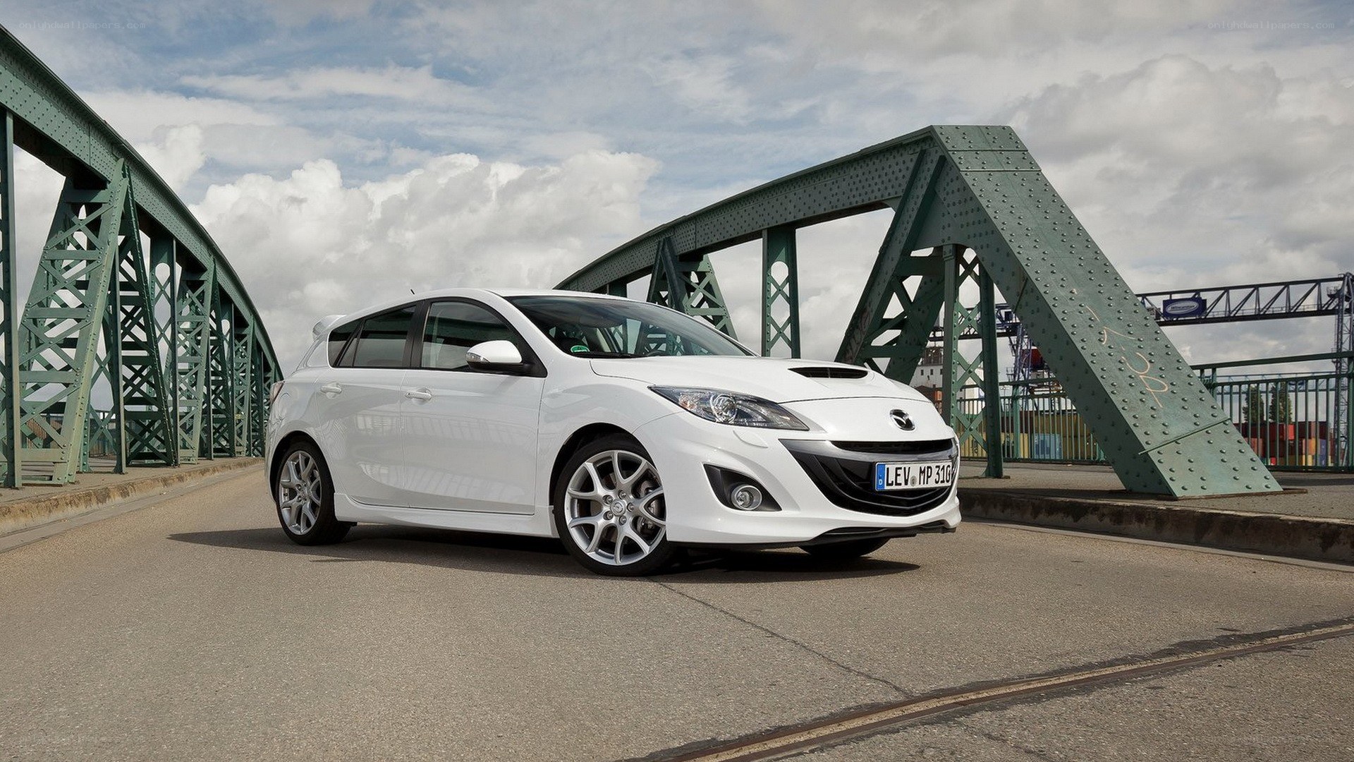 White Mazda 3 on a bridge