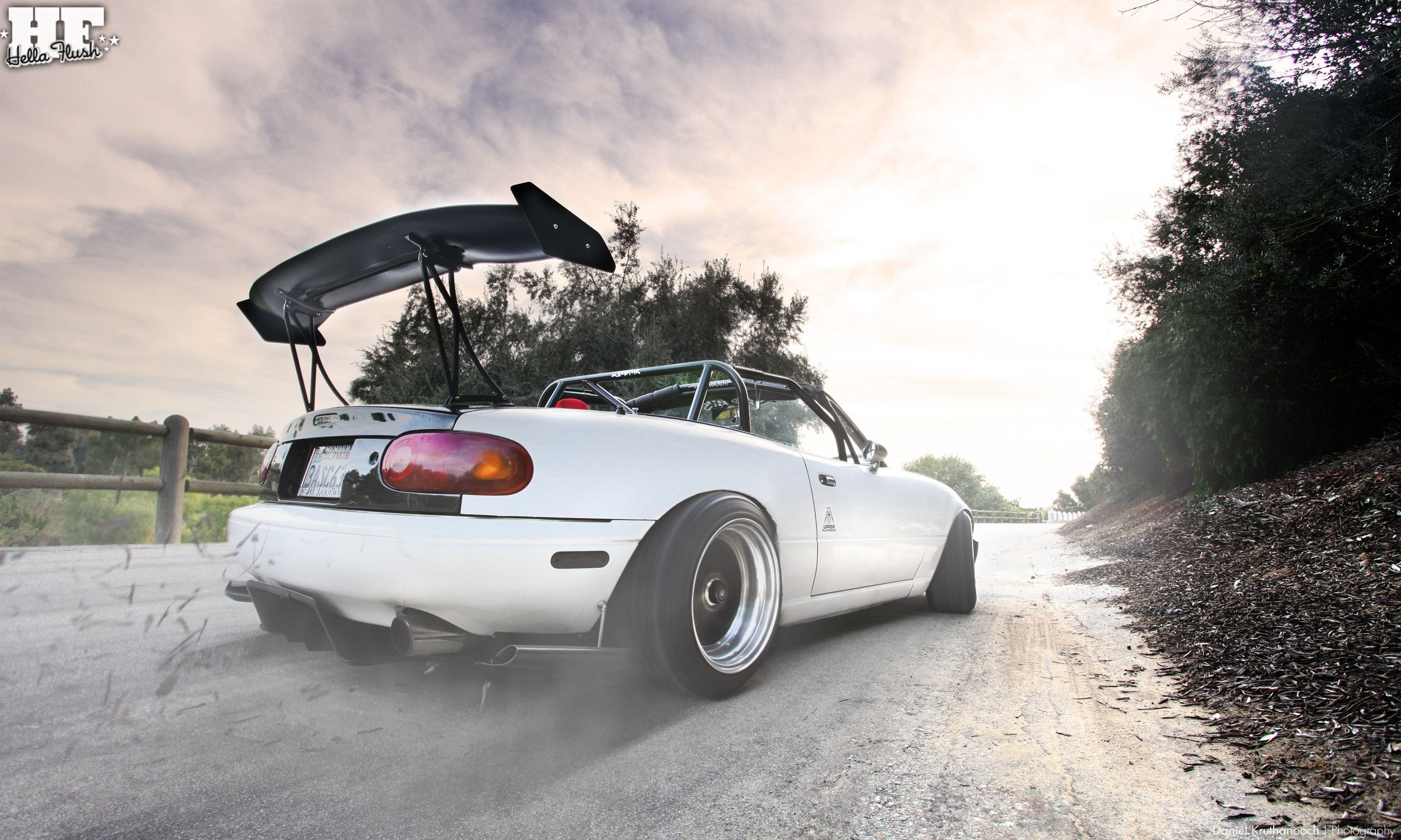 white mazda miata with rear wing