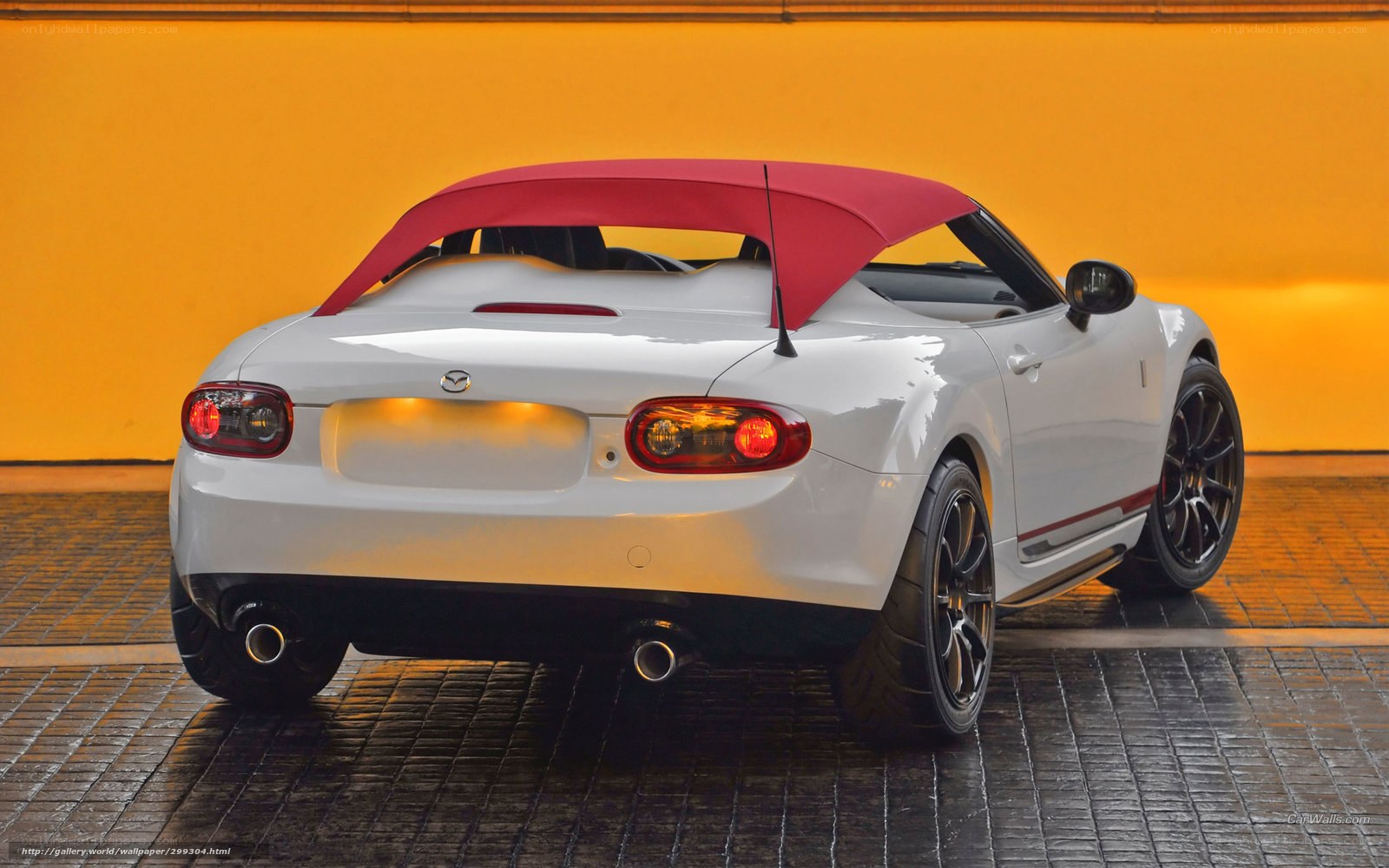 white mazda miata with red soft top