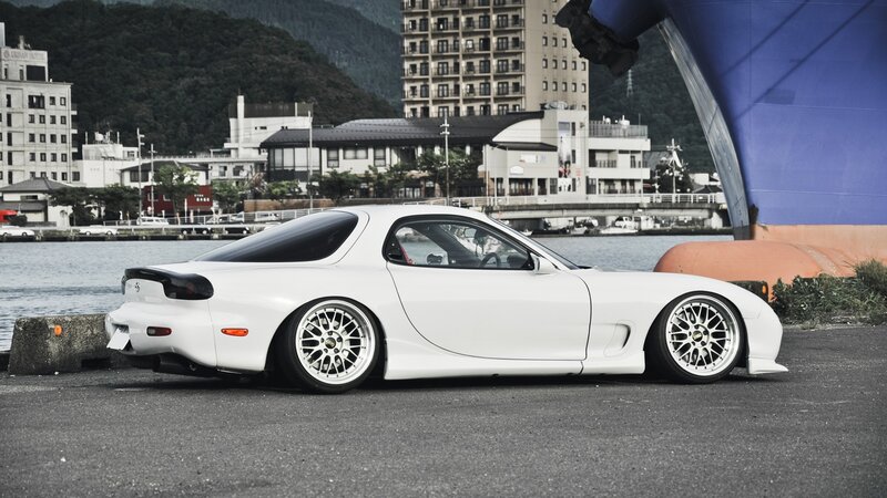 white mazda rx-7 at the harbor