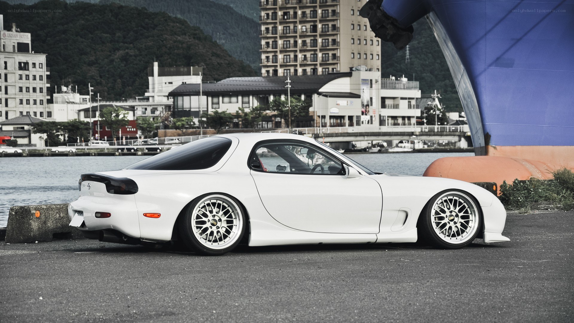 white mazda rx-7 at the harbor