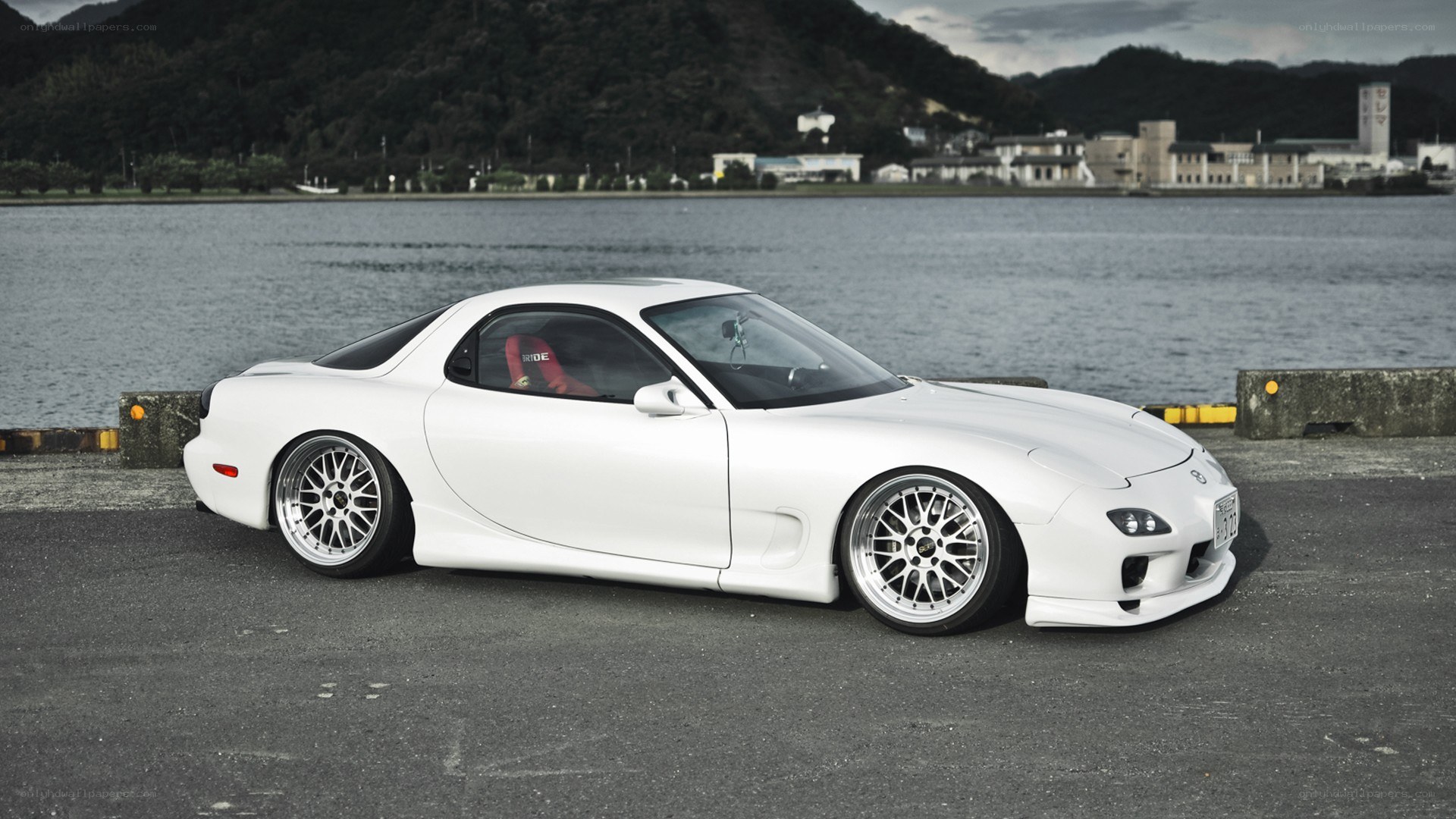 white mazda rx-7 by the water