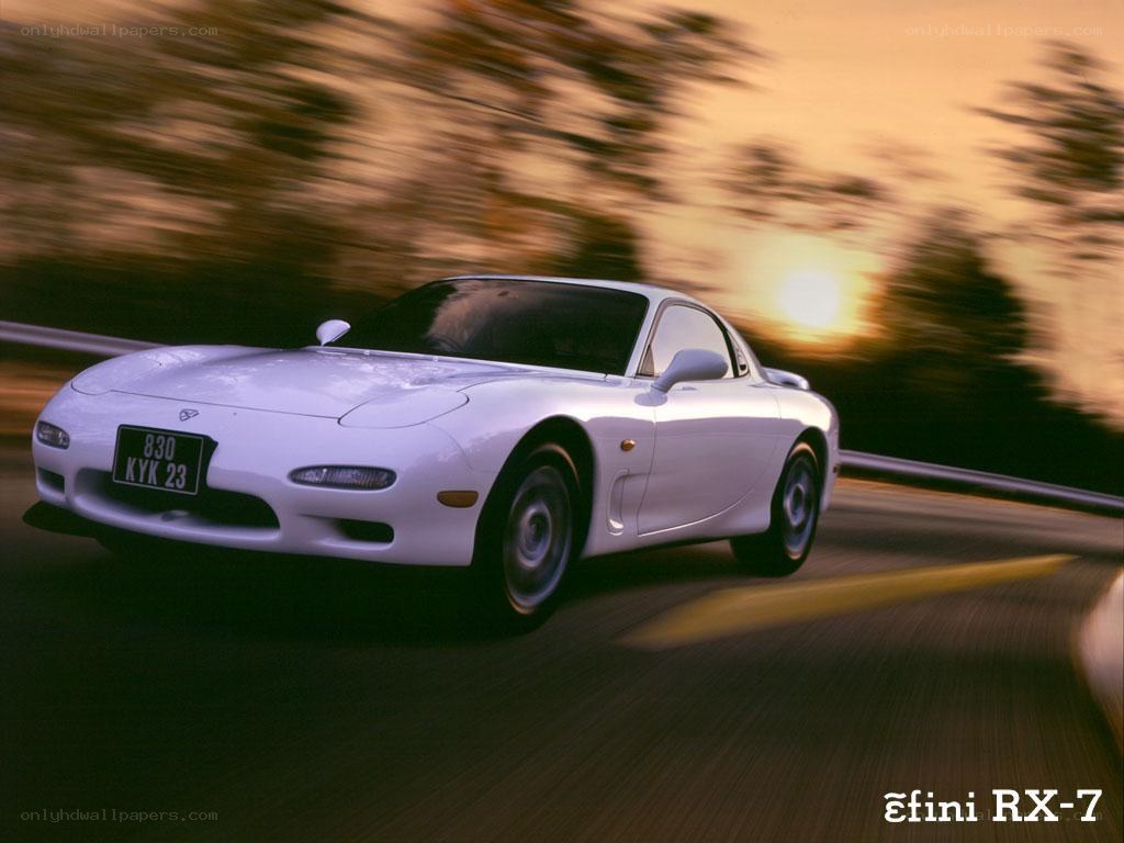 White Mazda RX-7 in motion