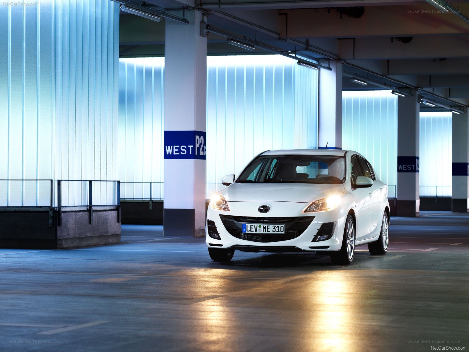 White Mazda3 in parking garage