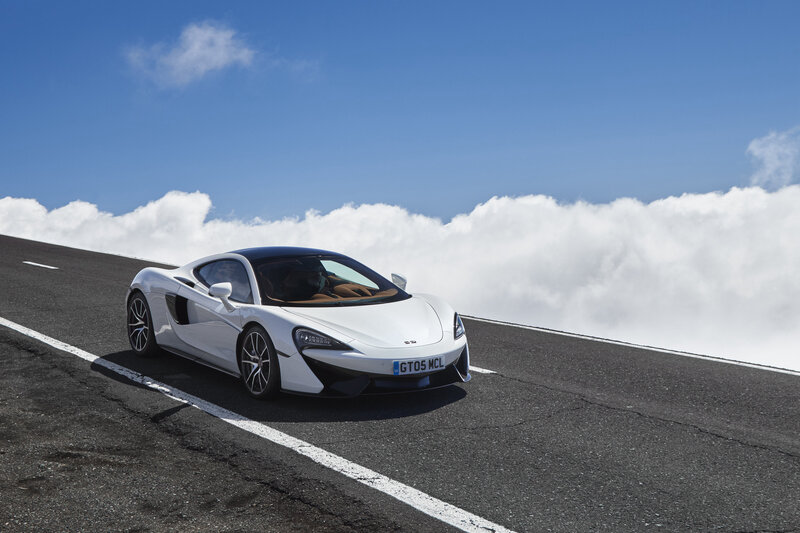White McLaren on a mountain road