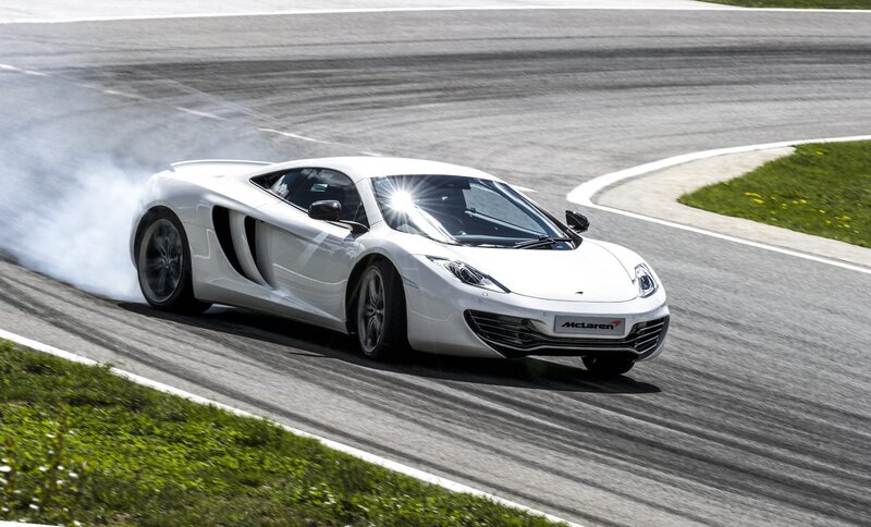 White McLaren on a racetrack
