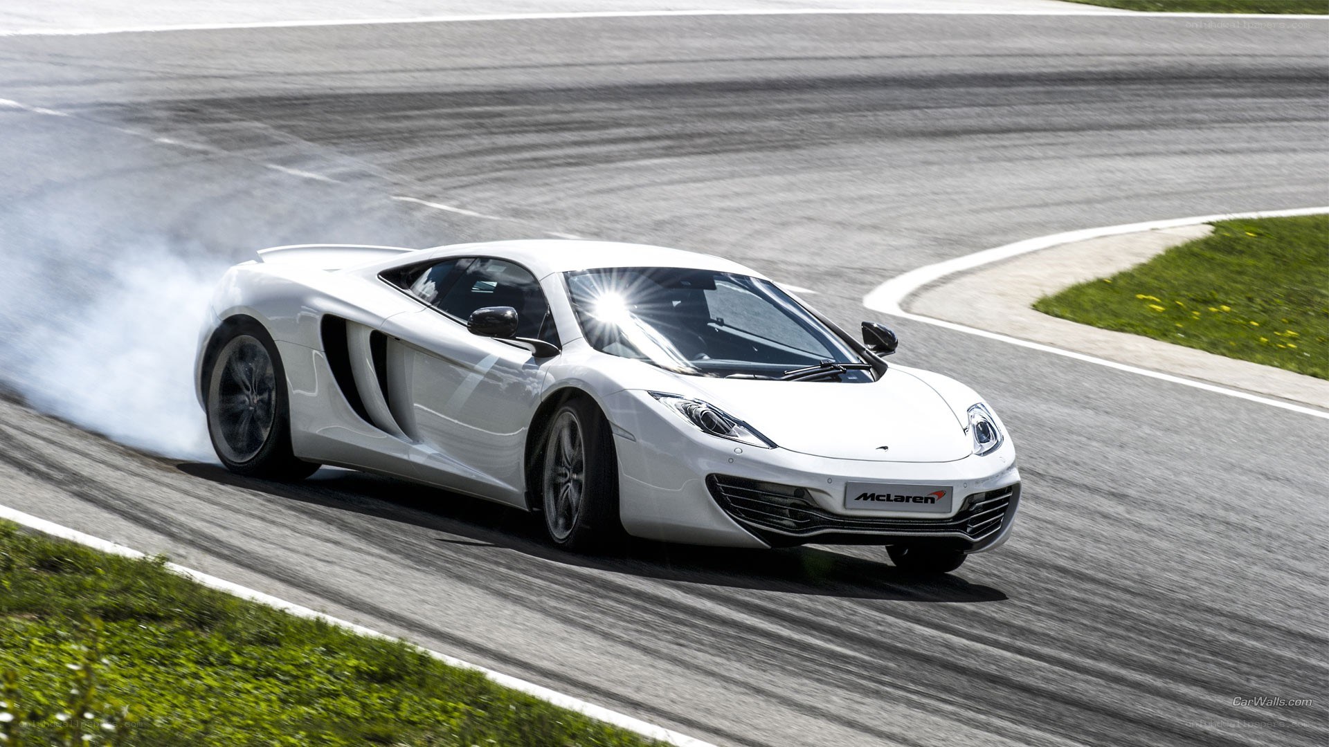 White McLaren on a racetrack