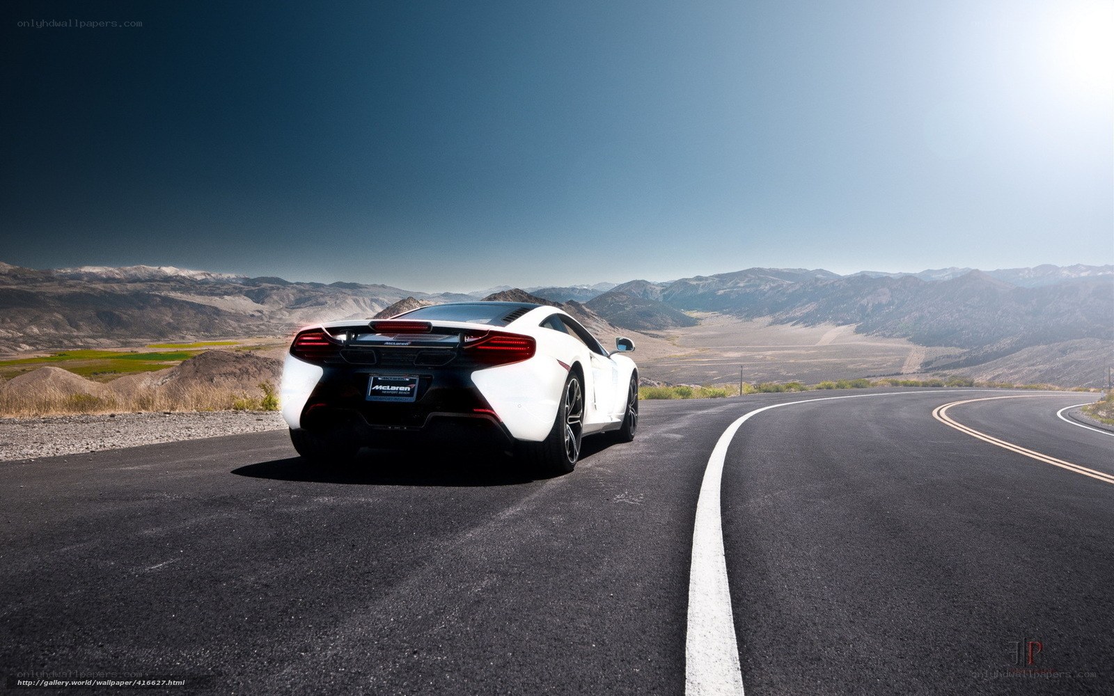 White McLaren on desert road