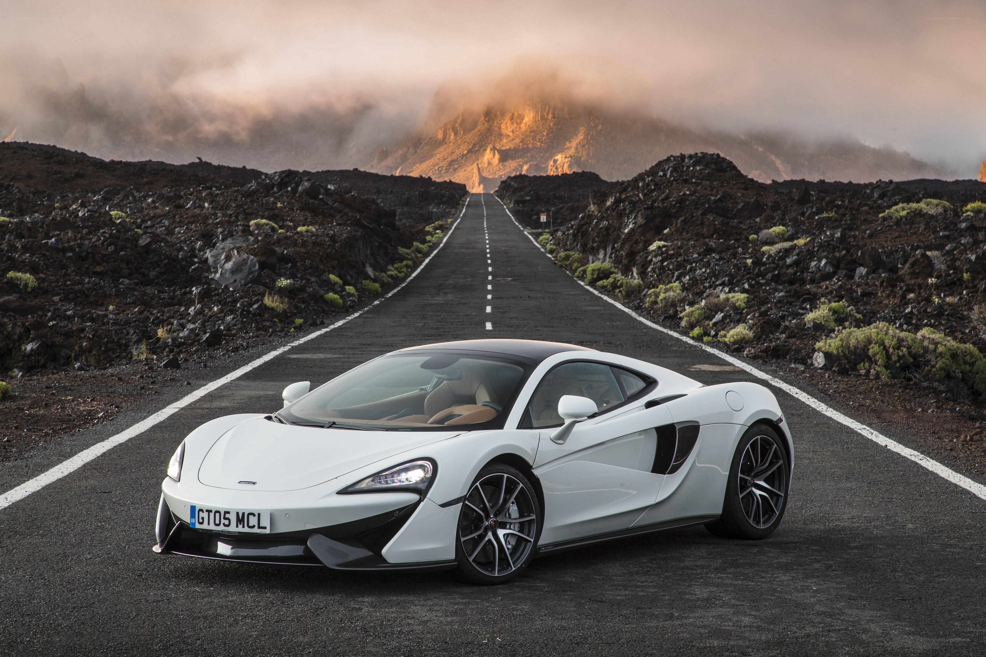 White McLaren on volcanic road