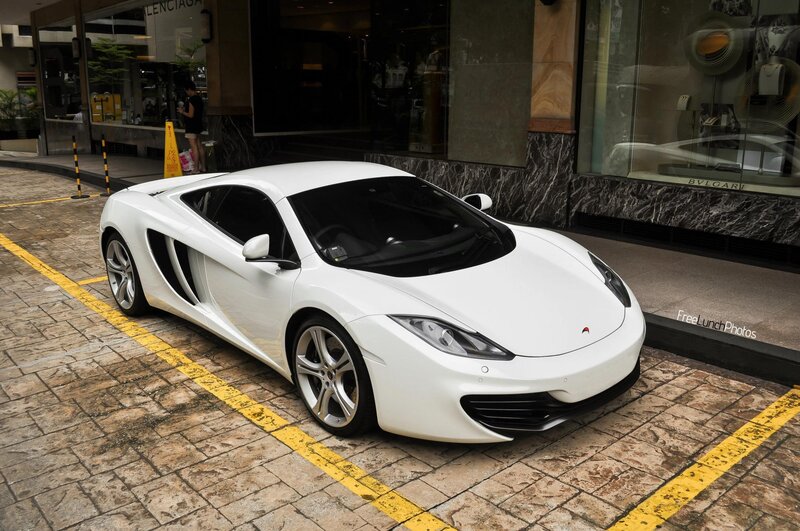 White McLaren parked on street
