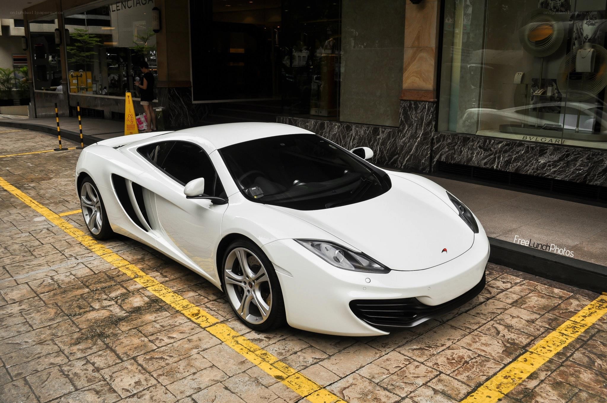 White McLaren parked on street