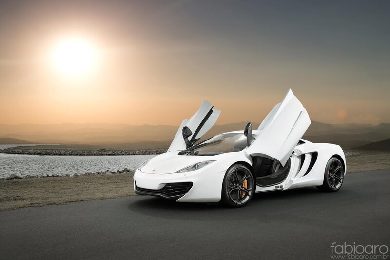 White McLaren sports car at sunset