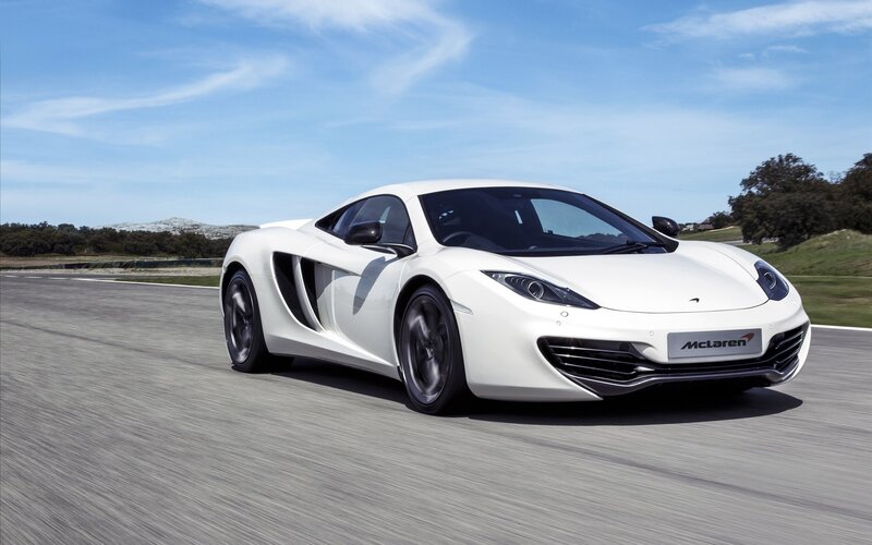 White McLaren Sports Car — Dynamic, Afternoon, Photograph, Race Track, Blue Sky, Trees