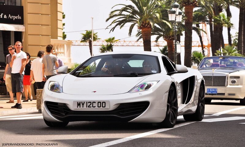 White McLaren sports car on street