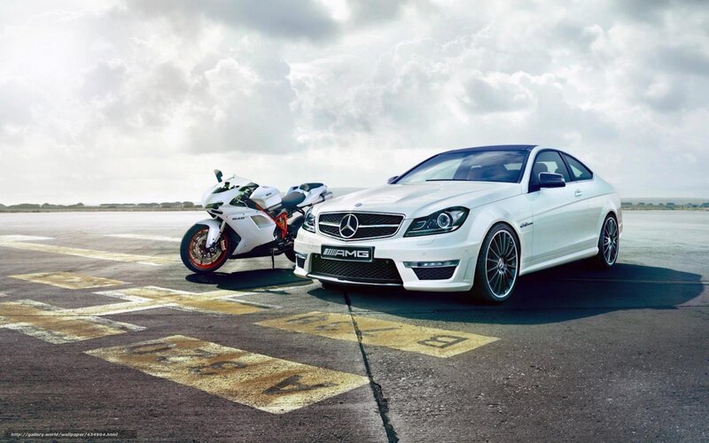White Mercedes-AMG and motorcycle