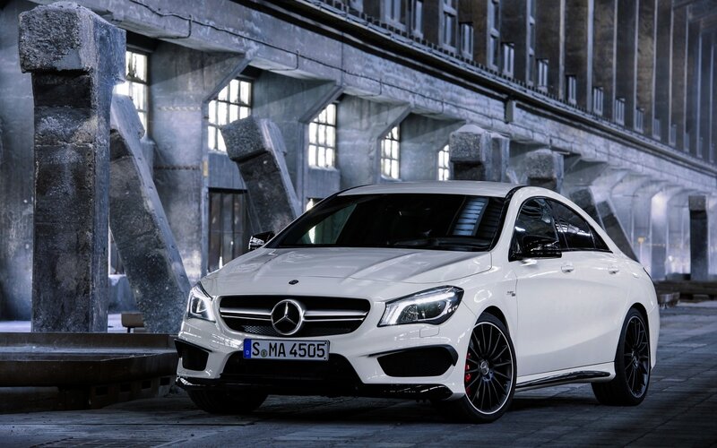 White Mercedes-AMG CLA in industrial setting