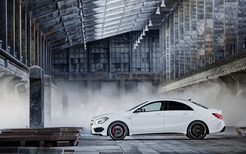 White Mercedes-AMG CLA in industrial setting