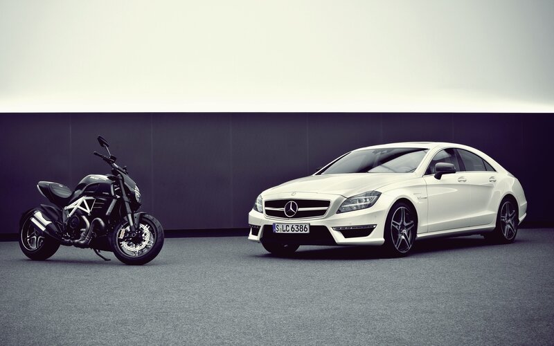 White Mercedes and black motorcycle