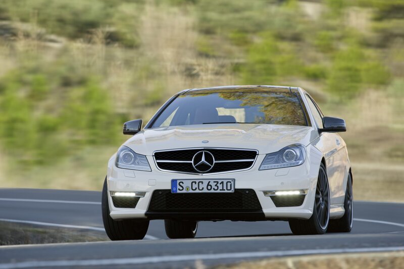 white mercedes-benz c63 amg driving