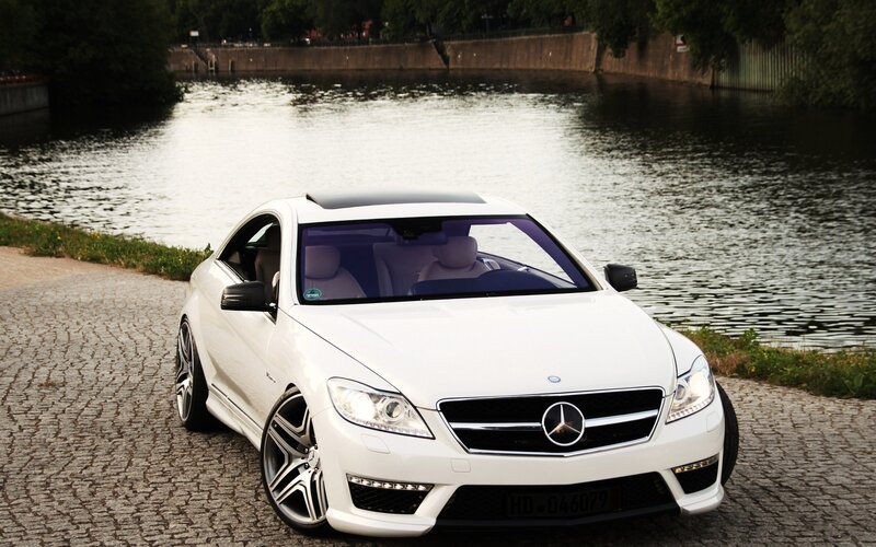 White Mercedes-Benz CLS parked by river