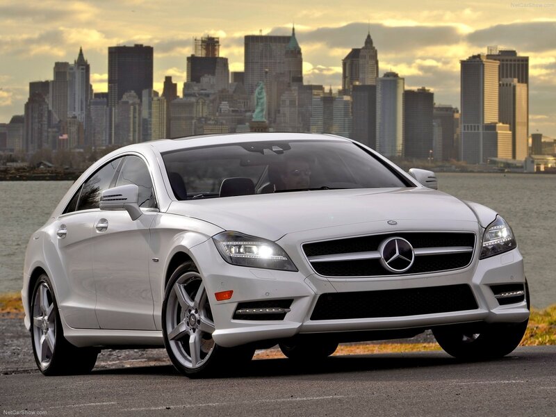 White Mercedes-Benz CLS parked by water
