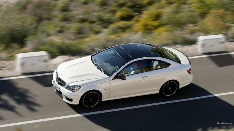 white mercedes-benz coupe driving