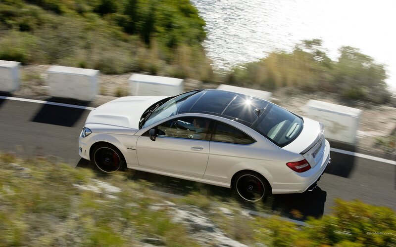 white mercedes-benz coupe driving