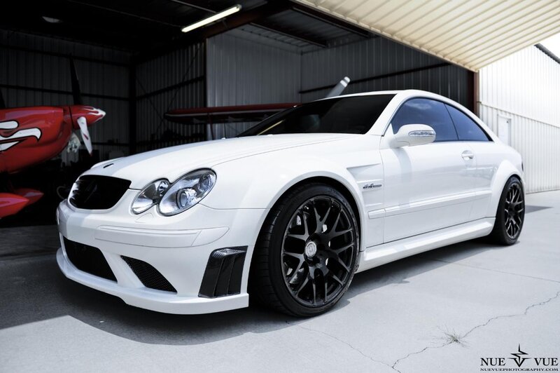 white mercedes-benz coupe in hangar