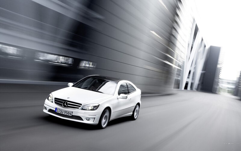 white mercedes-benz coupe in motion