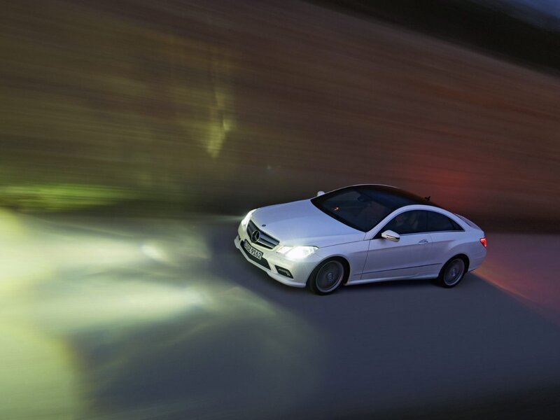 White Mercedes-Benz coupe in motion