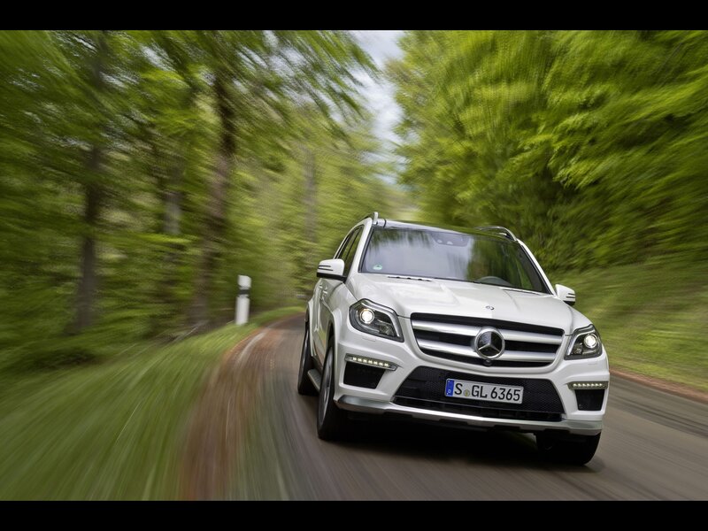White Mercedes-Benz GLK driving on a forest road
