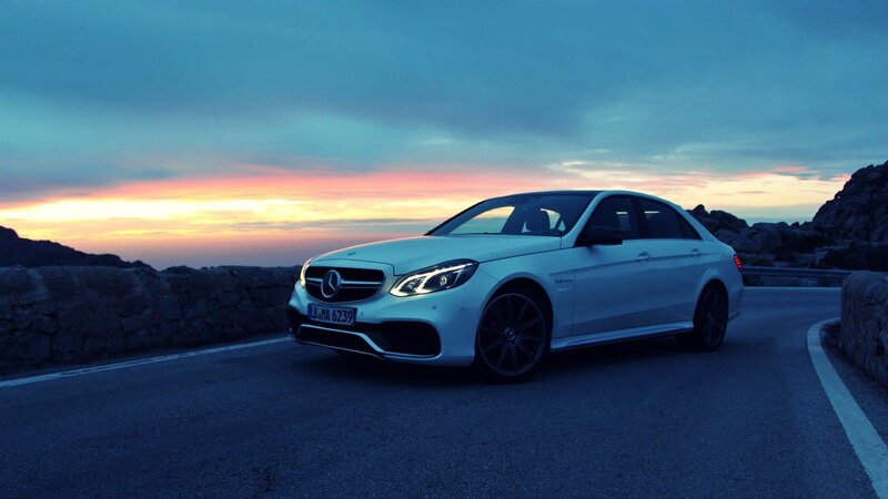 White Mercedes-Benz on a coastal road