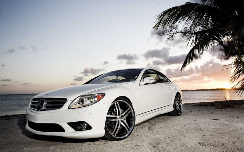 White Mercedes-Benz on beach at sunset