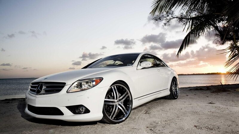 White Mercedes-Benz on beach at sunset
