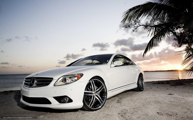 White Mercedes-Benz on beach at sunset