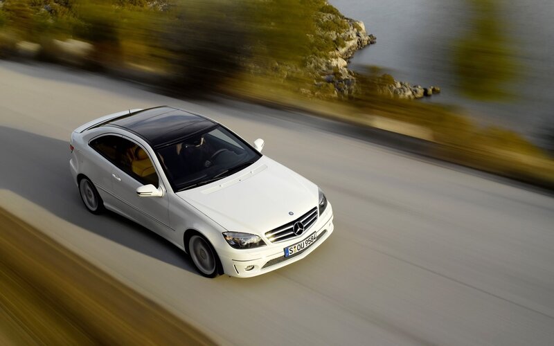 White Mercedes-Benz on coastal road