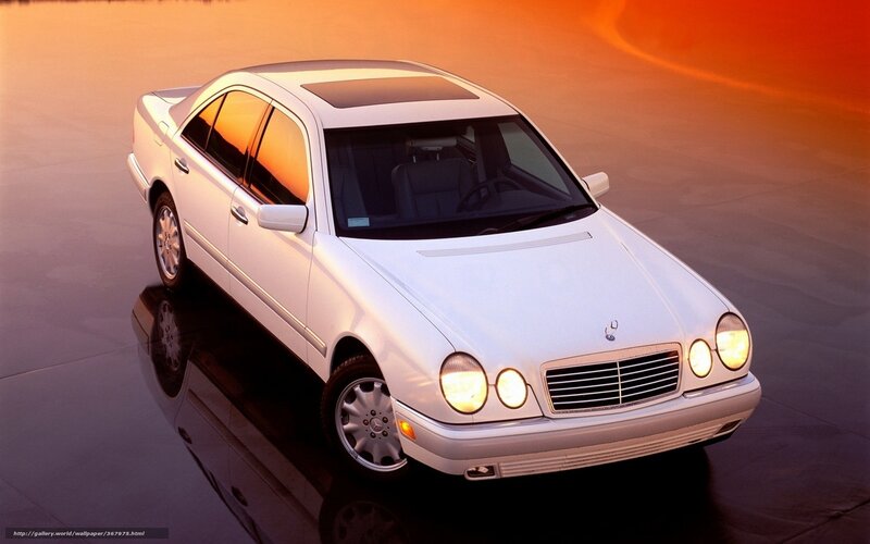 White Mercedes-Benz sedan at sunset
