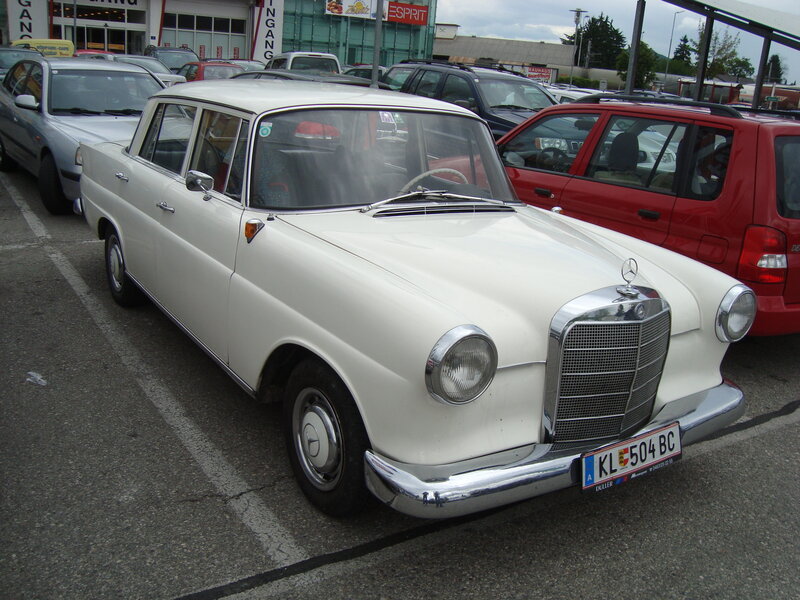 White Mercedes-Benz sedan in parking lot