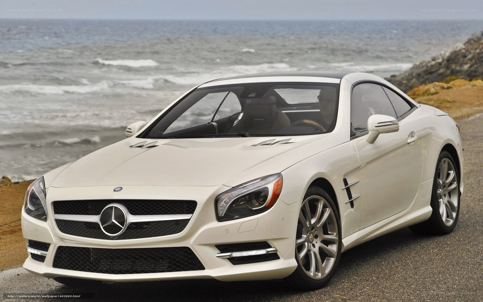 White Mercedes-Benz SL550 by the ocean
