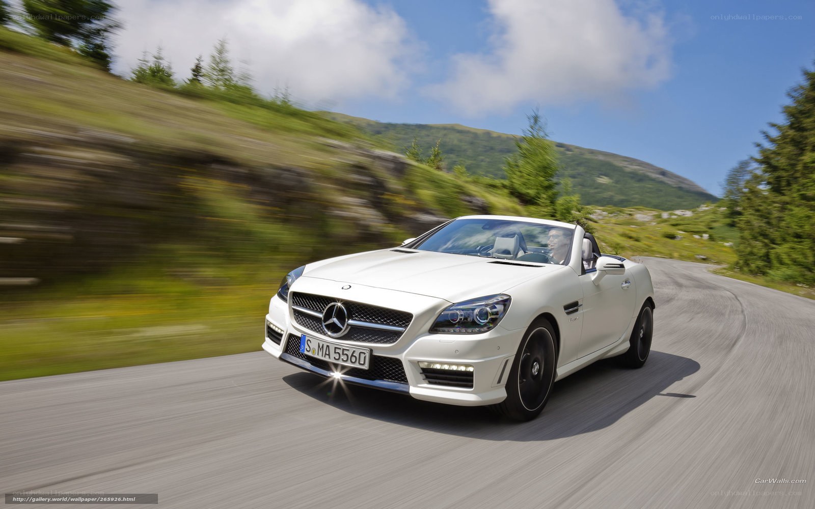 White Mercedes-Benz SLK driving on mountain road