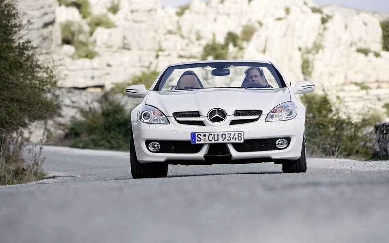 White Mercedes-Benz SLK driving on road