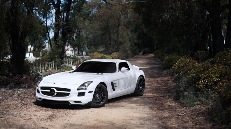 White Mercedes-Benz SLS AMG on a forest path